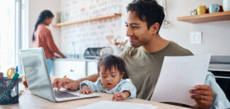 Man, baby on laptop