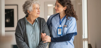 Caregiver assisting senior woman at home