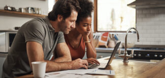 Laptop, couple planning in a kitchen on a laptop