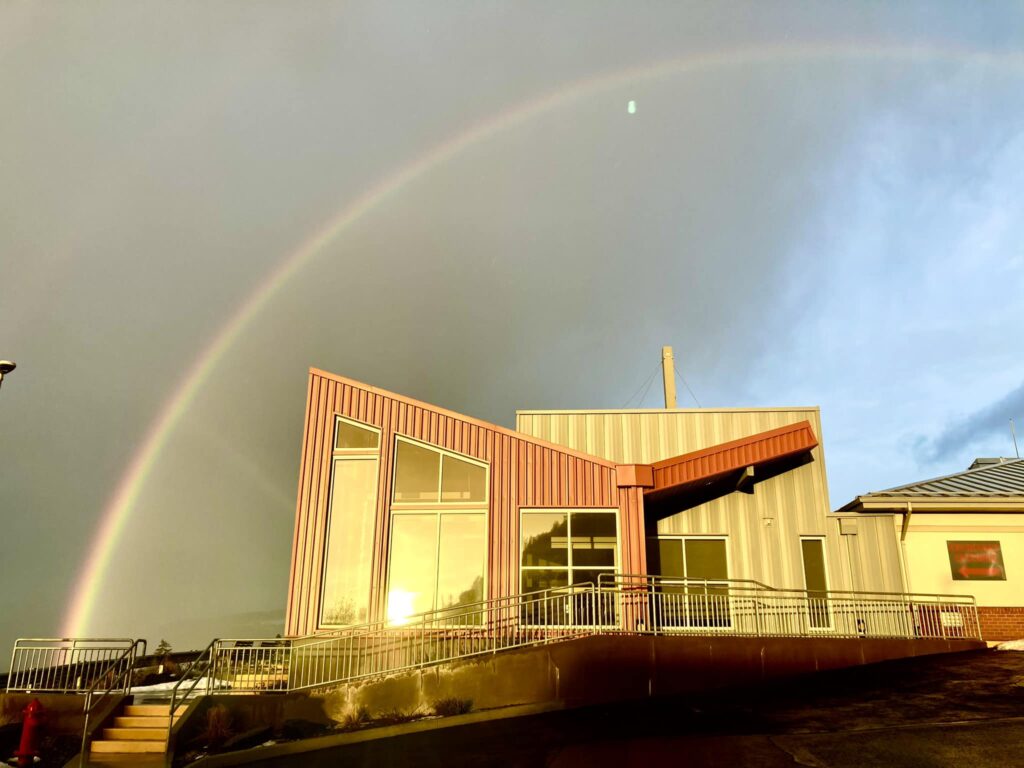 Building with rainbow in the sky